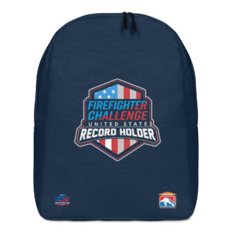 A navy blue backpack featuring the Firefighter Challenge United States Record Holder logo in the center with a red, white, and blue shield design. Two smaller logos are present at the bottom.