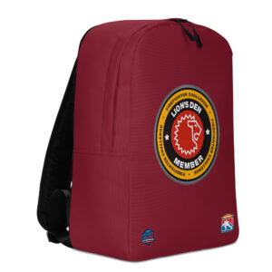 A red backpack with the Lion’s Den Member emblem in the center, featuring a lion’s head and the Firefighter Challenge logos near the bottom.