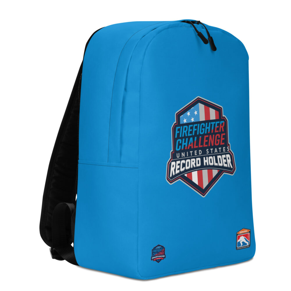 A blue backpack featuring the Firefighter Challenge United States Record Holder logo with a red, white, and blue shield design. Two additional small logos are positioned in the bottom corners.