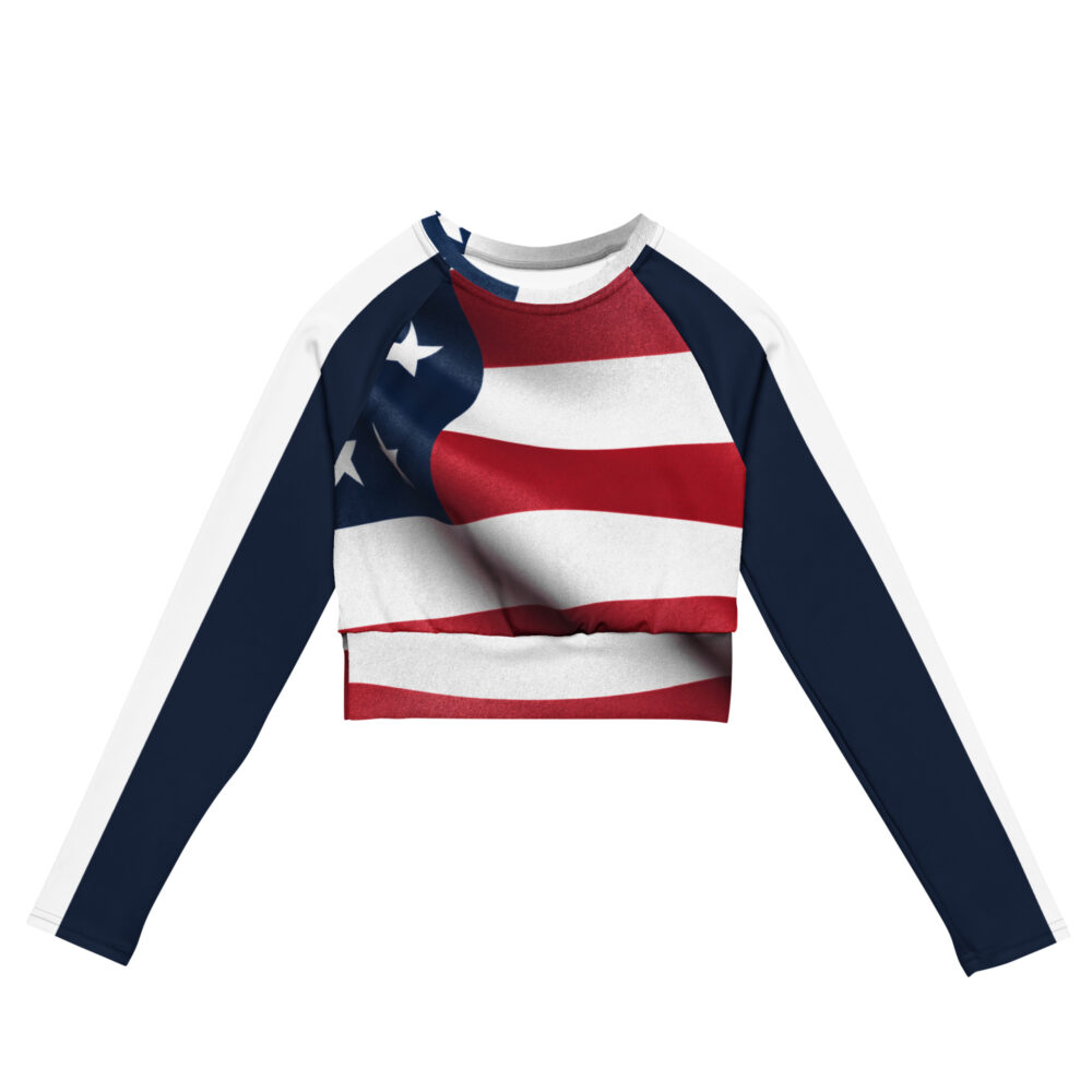 A long-sleeve cropped top with the American flag across the chest. The sleeves are navy with a white stripe running down each arm.