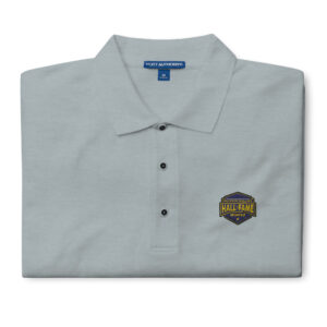 Image of a navy polo shirt with the Hall of Fame logo embroidered on the left chest, showcasing a professional and sharp design.