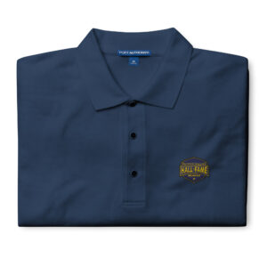 Image of a navy polo shirt with the Hall of Fame logo embroidered on the left chest, showcasing a professional and sharp design.